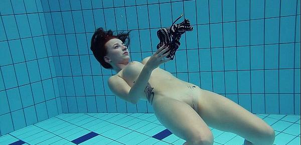  Redheaded Katrin is stripping underwater